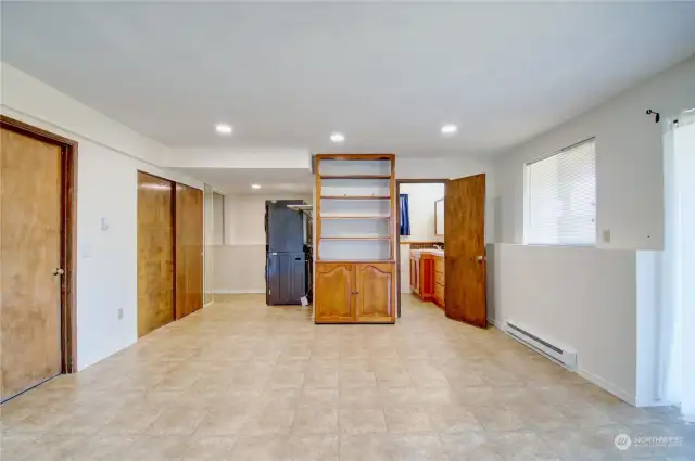 Downstairs living area. Doors to garage and closet area