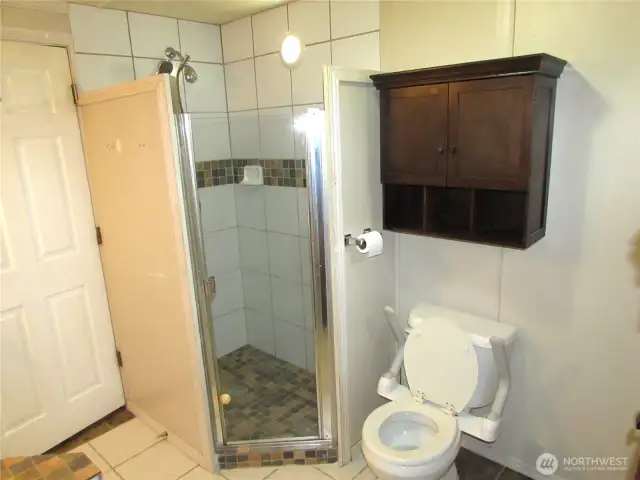 TILED WALK-IN SHOWER STALL.