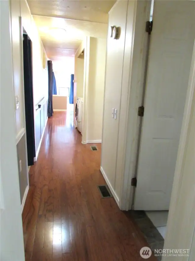 HALLWAY WITH BACK DOOR ON LEFT.