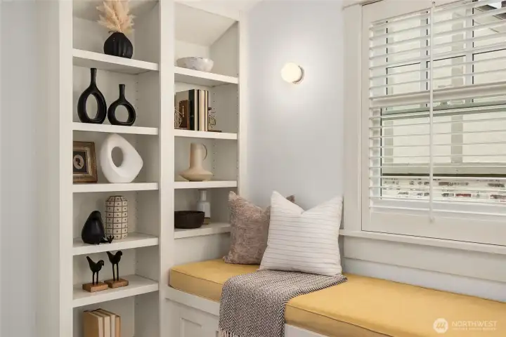 At the top of the staircase is a landing with a built-in window seat and bookshelves on both side.  Not pictured here is the laundry room.