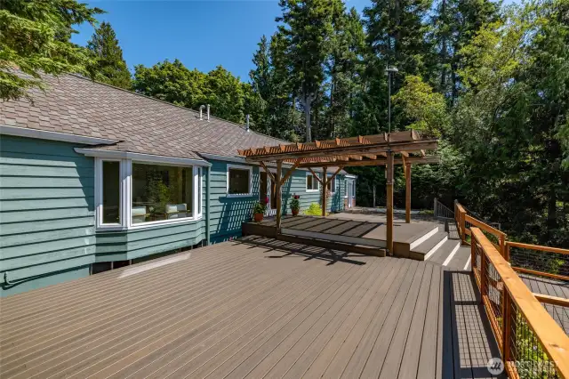 The back deck goes the length of the home and has trellised covering in the area near the dining room.