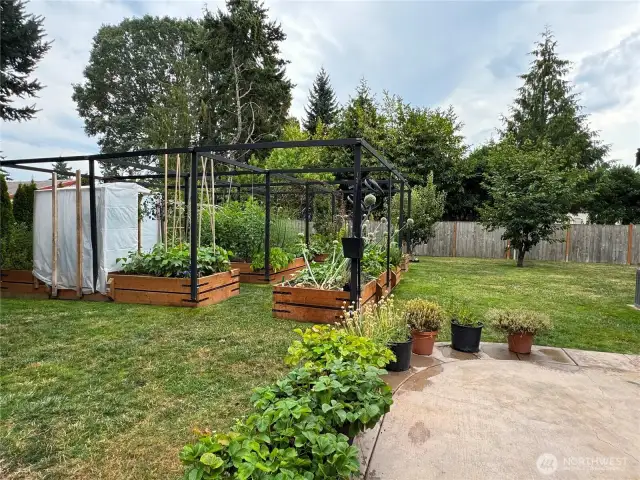 Side fence opens to another paved seating area.