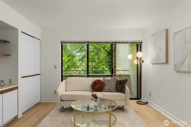Spacious living room features new LVP light oak flooring.