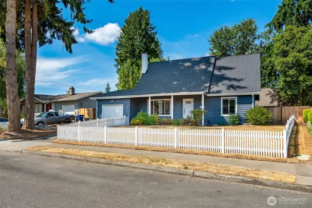 Front of home with fully fenced front yard