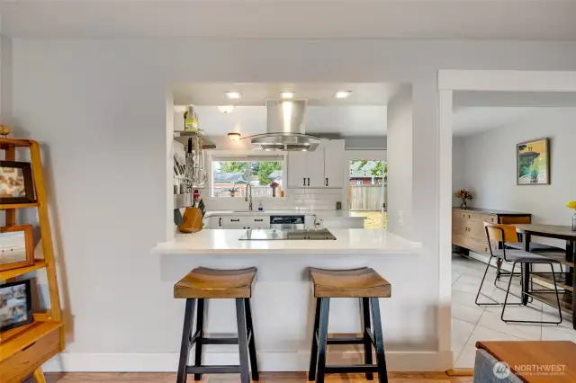 Bar seating combining living room and kitchen areas
