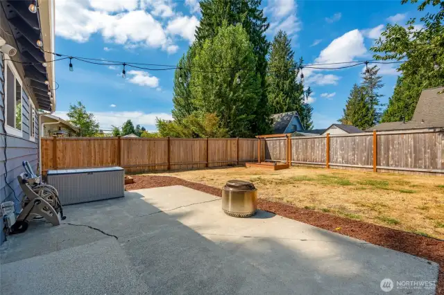 Large, level fully fenced backyard with patio