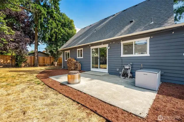 Large, level fully fenced backyard with patio