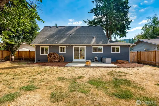 Large, level fully fenced backyard with patio