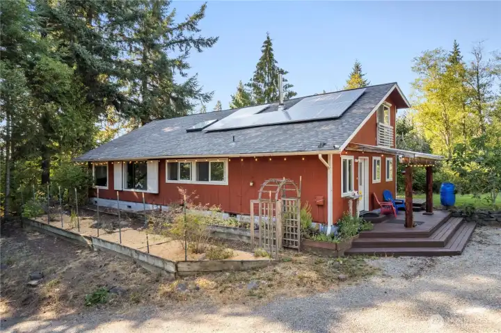 Culinary garden space just outside of the kitchen. Solar panels that feeds grid to minimize electric bill. Covered entry porch to enjoy your morning coffee.