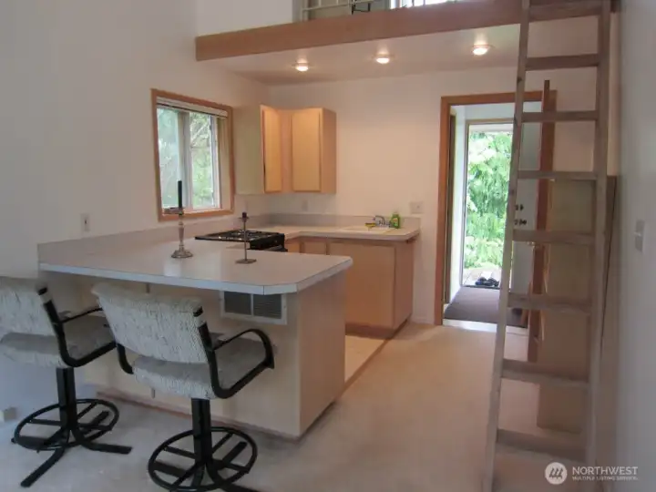 Kitchen and entry to previous apartment, now Primary Suite.