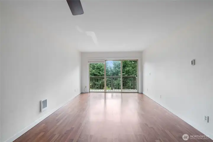Spacious living area with updated flooring and natural light.
