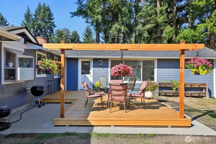 Terrific back deck with arbor to hang your flower baskets.