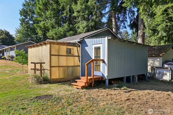 Back of the greenhouse and the separate entrance to the studio area of the detached garage.