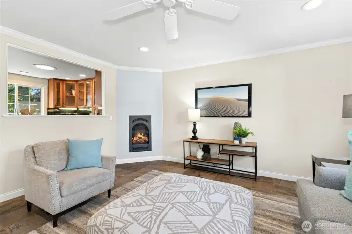 Gas fireplace and pass-through opening to kitchen. Perfect space for gatherings.