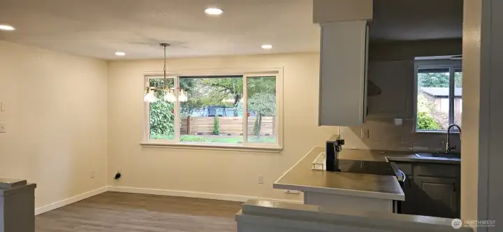 Formal dining room with wood stove and opens to kitchen with eating area too