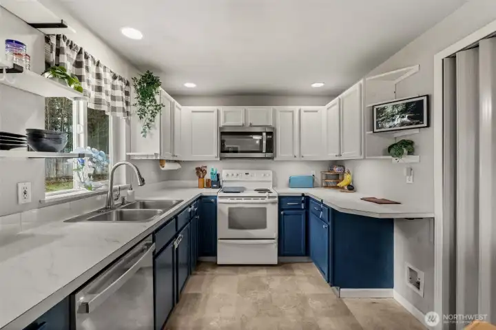 Bright and open kitchen with lots of cabinets and counter space