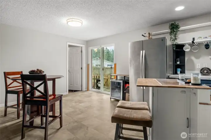 Kitchen opens to dining and sliding door to patio and backyard