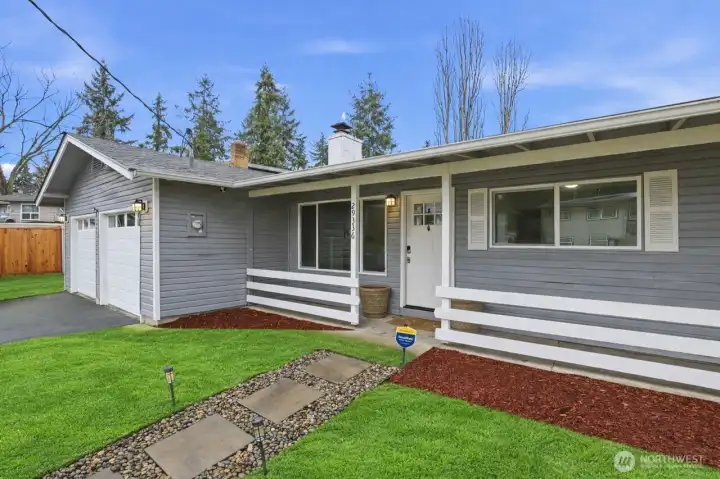 Covered porch greets you as you walk up the lighted pathway