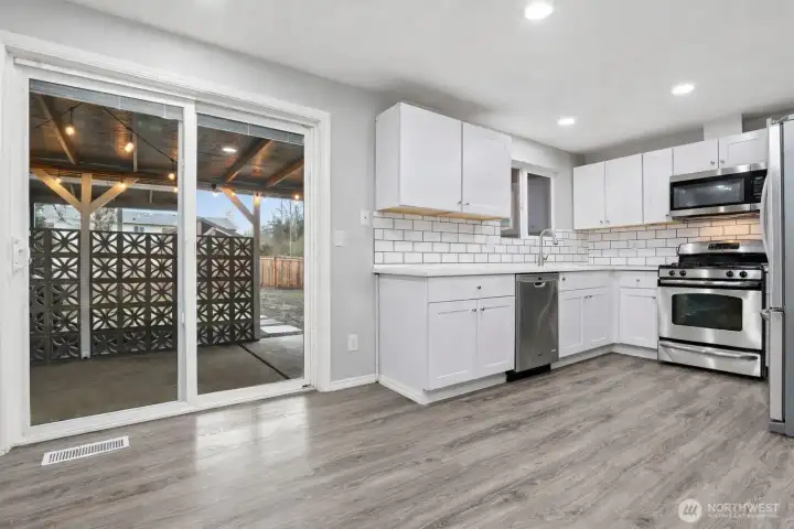 Sliding doors to covered back porch and level back yard with privacy screen - perfect spot for a hot tub!