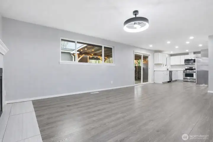 Large family room and dining area with wood burning fireplace.