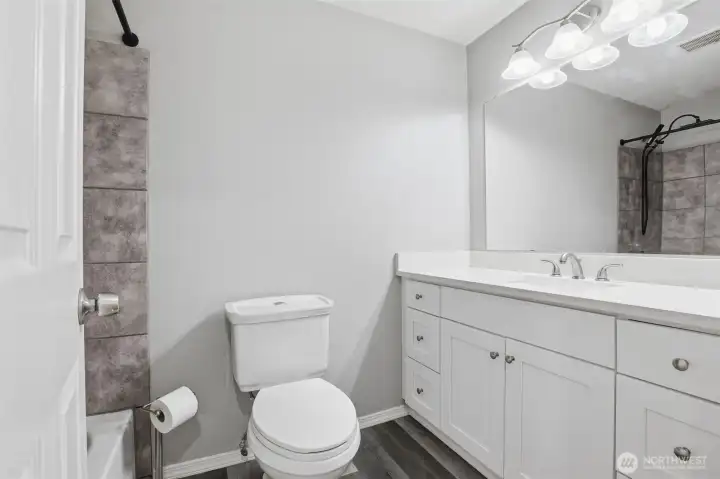 Full hall bath shower-tub combo with beautiful tile and upgraded shower hardware