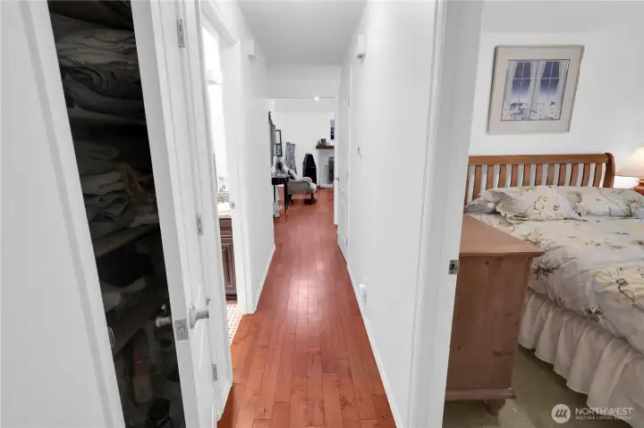 Hallway on upper floor has engineered plank hardwood.