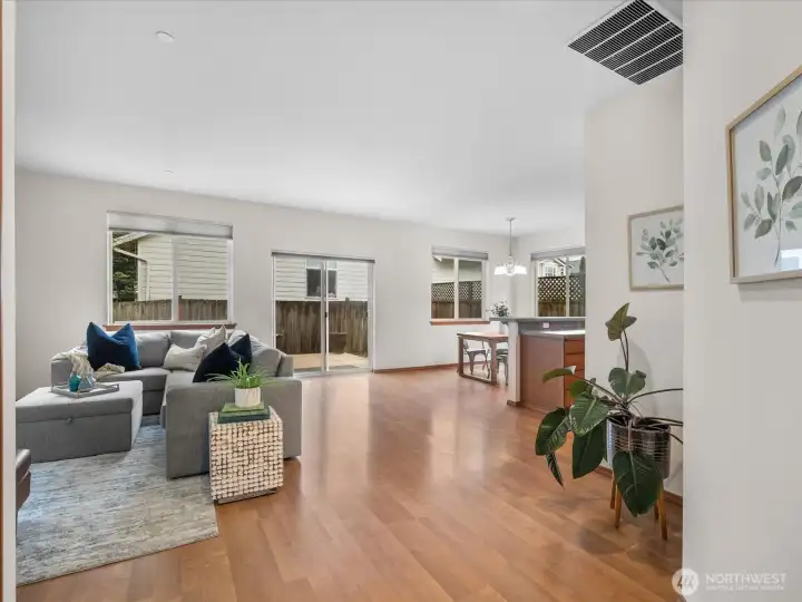 Experience seamless indoor / outdoor living in this bright open concept great room featuring engineered hardwood laminate floors, and a sliding glass door that leads to your private backyard retreat