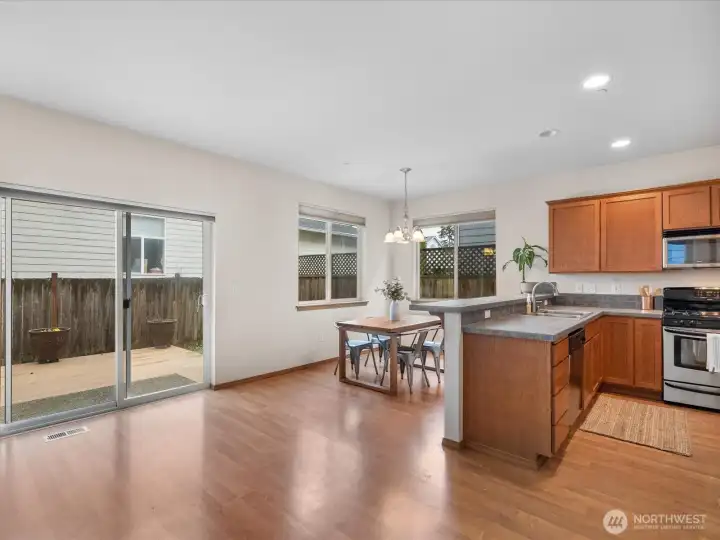 Generous open plan living area flooded with natural light leading to dining nook flooded with natural light and sliding doors leading to your own deck and private back yard - all adjacent to your modern kitchen - perfect for entertaining