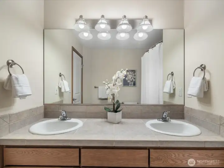 Hall full bath located on the second floor. The double sinks offer incredible convenience while the large vanity provides generous storage below.