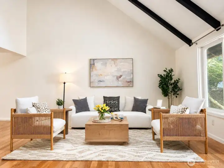 Spacious living room with vaulted ceilings and exposed wood beams