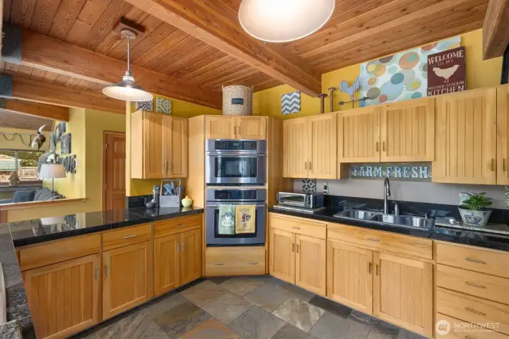 Spacious kitchen with stone counters, beautiful cabinets, radiant heated floors
