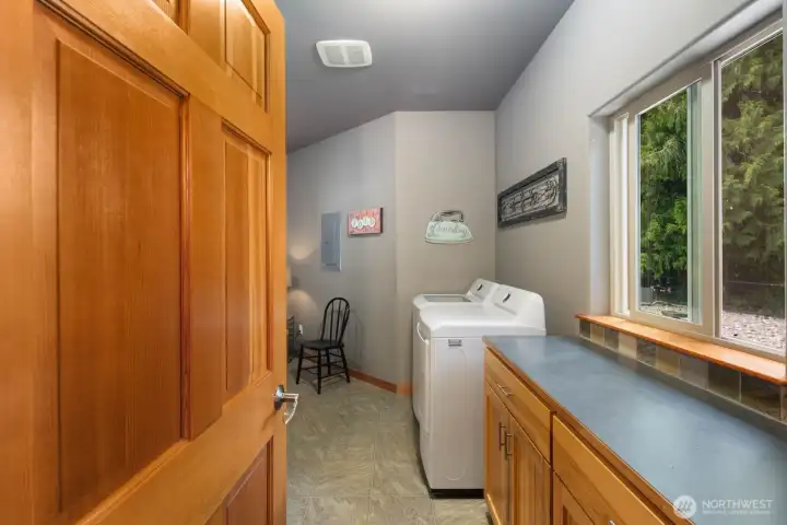 Huge laundry room with lots of storage, and it's own bathroom