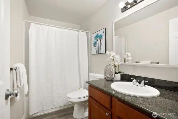 Beautiful Full Bath with Luxury Vinyl, Granite Counters and Cherry Cabinets