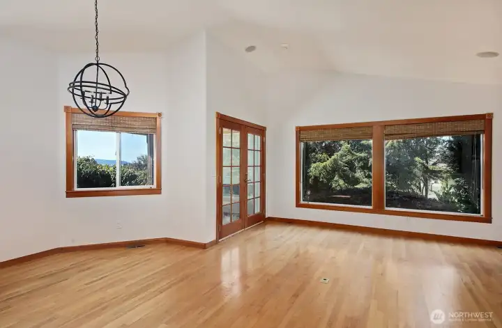 Hardwood flooring through the living, dining, kitchen area and hallway.
