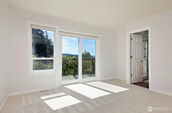 The primary bedroom has a slider to the deck.