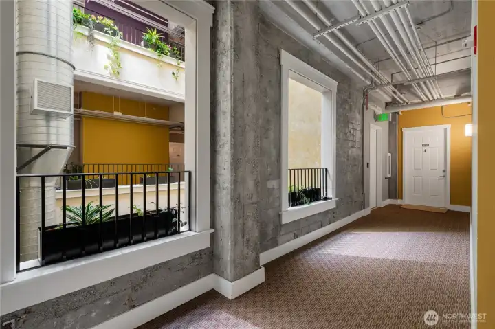 Bright interior building hallways open to 4-story skylit atrium Bright interior building hallways open to 4-story skylit atrium