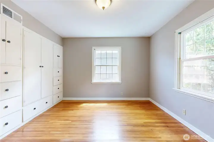 bedroom 1 with hardwood floor and built ins