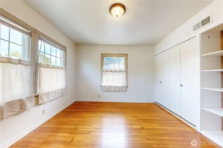 bedroom 2 with hardwood floor and built ins