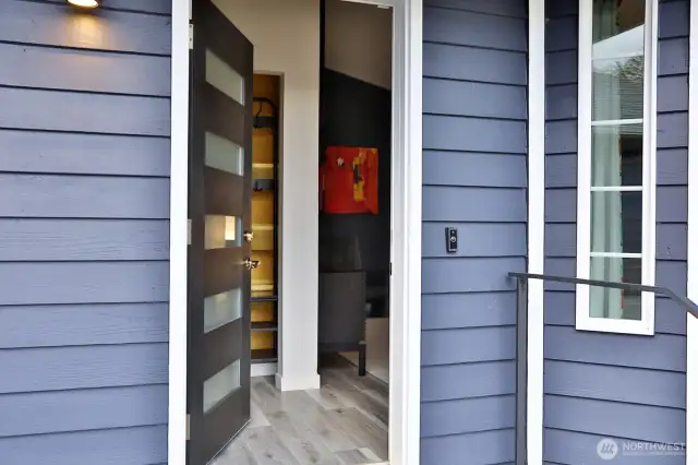 Let's go inside. Upon entry (love that new door!) there is a convenient coat closet. The living room is to your right and the kitchen to your left. LVP flooring is one of the many updates.