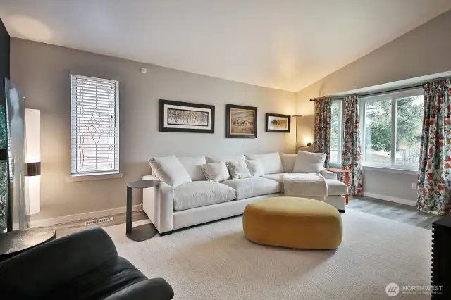 Your back is to the sitting area adjacent to the kitchen and you are looking back at the living room. The hallway to the three bedrooms is to your back left (not in photo).