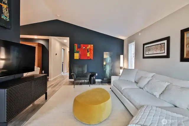 Another view of your living room with a glimpse of the hallway (straight ahead) and the sitting area off of the kitchen to your left, before the hallway entrance. Full bath is the first door on your left in the hallway.