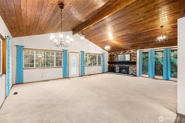 Vaulted ceilings and gas fireplace living room dining area