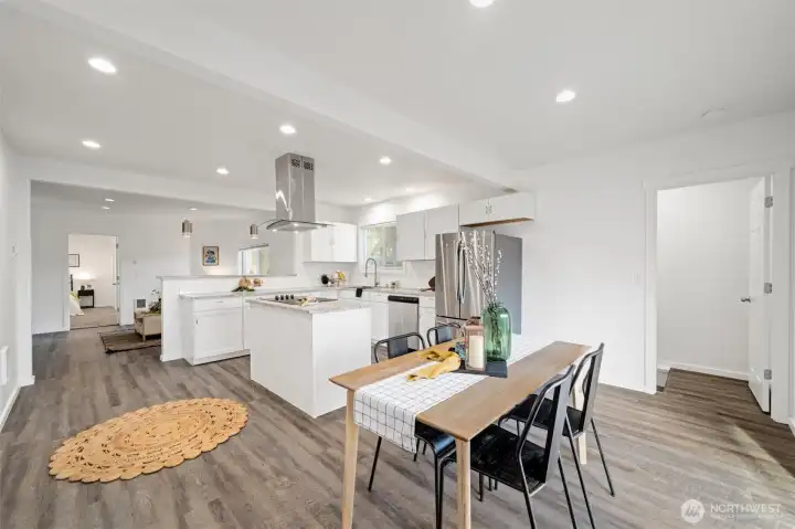 The openness of the kitchen and dining and living areas are great for entertaining! The door to the right leads to the family room in the basement.