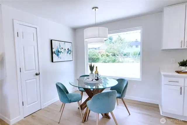 Dining Area with hanging lamp in front of center piece bay window