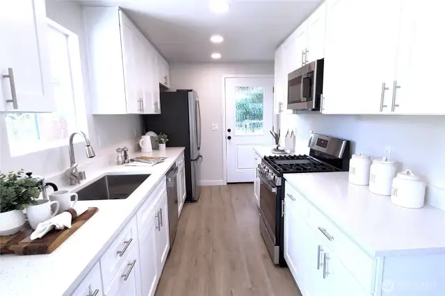 Kitchen facing South with all new appliances, sink, cabinets, & quartz countertops