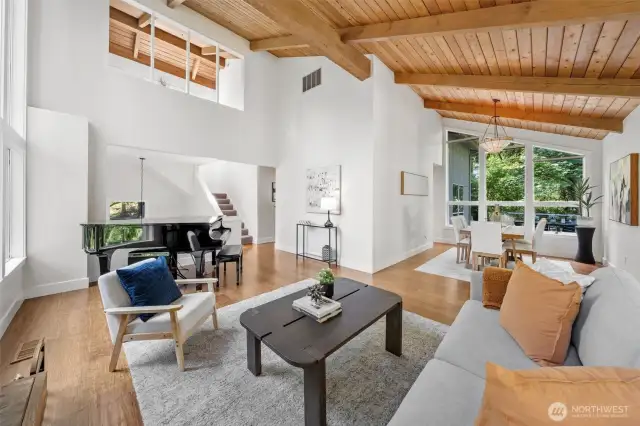 The open-concept living and dining spaces flow effortlessly beneath vaulted ceilings—offering style, comfort, and serene views from every angle.