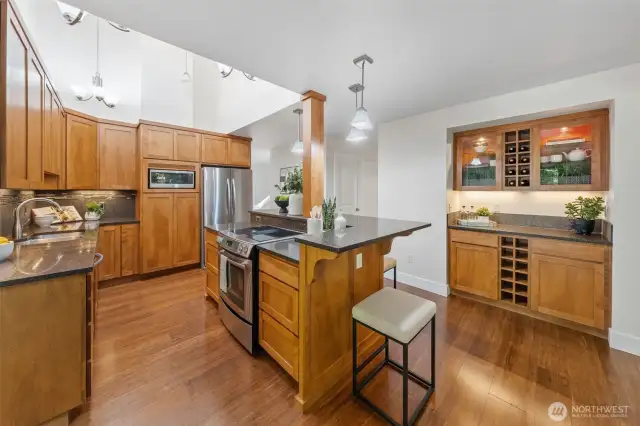 This thoughtfully designed kitchen features a built-in bar with wine storage and room for bar seating—ideal for casual conversation or keeping the chef company while meals come together.