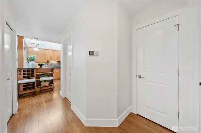 A central hallway just off the kitchen provides direct access to the laundry room, full bath, additional storage and two bedrooms—bringing ease and flow to everyday living.