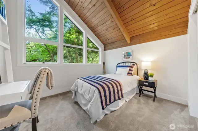 Bedroom Three enjoys peaceful treetop views and a versatile layout—perfect for guests, creative pursuits, or a dedicated home office. Notice the window trim package.