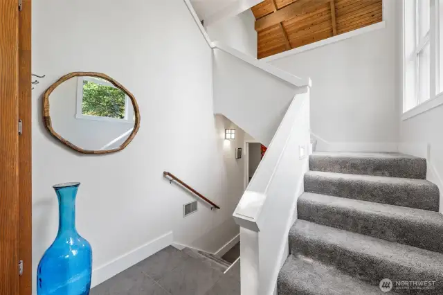 Crisp lines and natural light define this thoughtfully designed multi-level home. The stairs lead up to the main living area and down to a spacious lower-level rec room, with each level offering a distinct yet cohesive living experience.